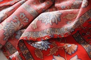 Detailed close-up of ruffle dress fabric with blue floral patterns and linen texture