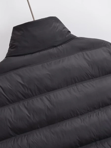 Macro detail of the wide horizontal quilting on this black waterproof padded jacket