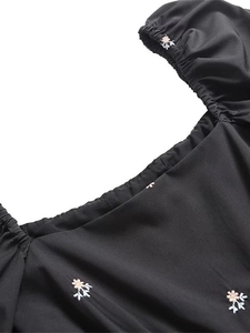 Black Y2K midi dress with square neck, elastic smocking, and colorful flower embroidery