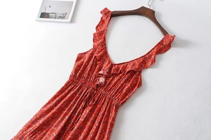 Detailed side view of a red floral dress with ruffled V-neckline and drawstring waist