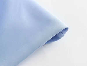 Macro detail of sky blue Y2K tube top showing premium textured fabric and fine stitching