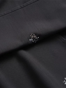 Close-up of black summer high waist midi dress with intricate 3D floral embroidery details