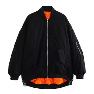 Detail of MA-1 bomber jacket with orange lining and utility pocket on the sleeve