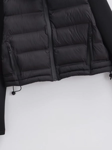 Quilted black puffer jacket with zip pockets and adjustable drawstring hem detail
