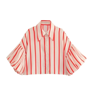 Detail of red and white vertical striped shirt with puff sleeves and buttoned front