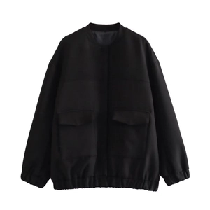 Detailed close-up of a black Y2K bomber jacket featuring cargo pockets and ribbed cuffs