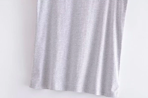Detail of the high-quality stitching and light grey marl texture on the soft casual t-shirt hem