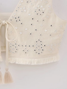 Detailed embroidery and shisha mirror work on beige bohemian tassel crop top fabric