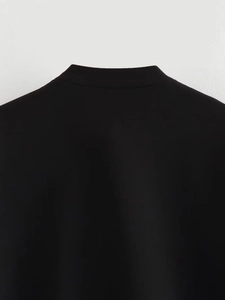 Detail view of the sleek black bomber jacket stand collar with premium fabric texture
