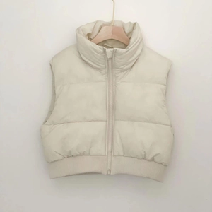 Detail of cream white padded vest featuring high collar and ribbed elastic hemline