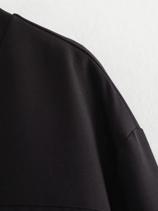 Macro view of seam stitching and twill fabric texture on a black bomber jacket