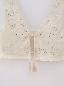 Detailed embroidery with silver sequins and beadwork on a cream Y2K style tassel vest
