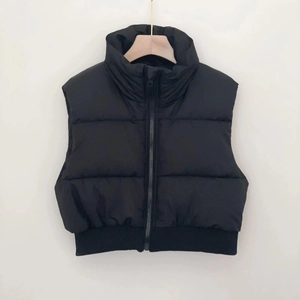 Close-up of the standing collar and front zipper detail on a black padded vest