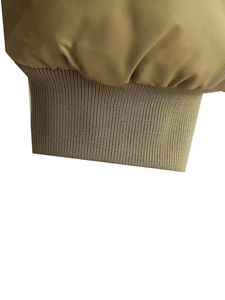 Detailed macro view of high-density knitted ribbed cuff on khaki flight jacket