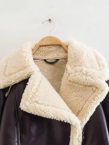 Detail of deep purple faux leather jacket showing thick cream fleece lining and collar