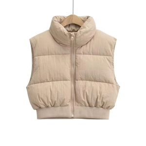 Detail of light beige cropped puffer vest with stand collar and horizontal quilting