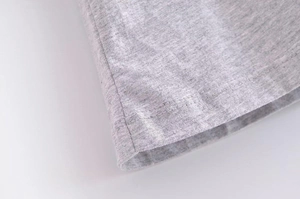 Macro shot of heather grey knit fabric showing premium double-needle stitching detail