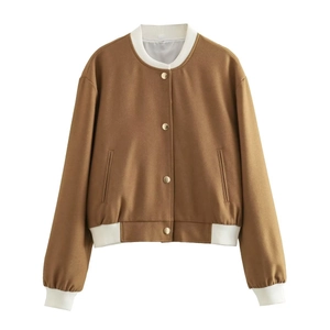 Detailed close-up of brown and white color-block bomber jacket with golden metal buttons