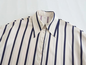 Detail of the navy vertical stripes and beige woven fabric on the S-size collared shirt