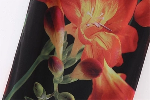 Close-up of vibrant floral print on black mesh fabric for a summer Y2K style dress