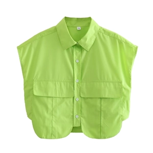 Detail view of neon green sleeveless shirt with lapel collar, chest pockets and white buttons