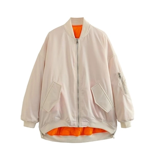 Oversized beige bomber jacket with orange lining and utility sleeve pocket detail