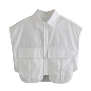 Detail of white sleeveless utility shirt featuring lapel collar and large flap pockets