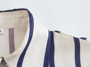 Close-up of blue and white vertical striped shirt detailing the collar and fabric texture