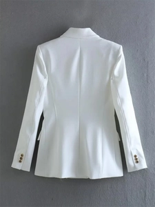 Close-up of white blazer back with slim tailoring and gold embossed buttons on cuffs