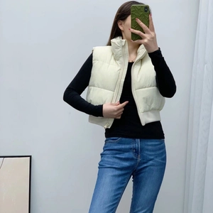 Y2K style white cropped puffer vest with stand collar and horizontal quilting detail