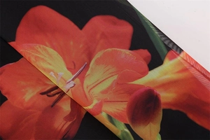 Close-up of vibrant floral mesh fabric with high-quality stitching on a Y2K dress