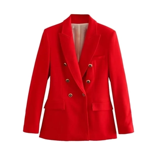 Close-up of golden embossed metal buttons and flap pockets on red double-breasted blazer