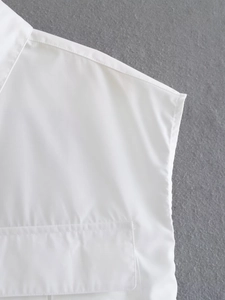 Detail view of white sleeveless Y2K shirt showing lapel collar and flap pocket stitching