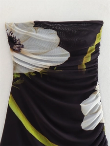 Detail of floral print mesh dress with white flowers and side ruched pleated fabric texture
