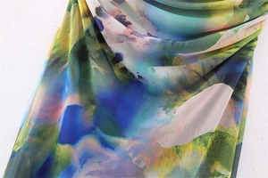 Close-up of lightweight mesh fabric featuring vibrant floral print and sheer texture