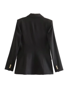 Detail view of female black blazer sleeves with three decorative gold buttons