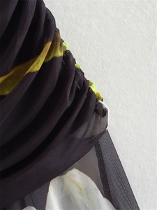 Detail view of ruched mesh fabric with vibrant prints for a Y2K midi dress style