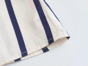 Detailed macro view of cream-colored striped shirt with premium double stitching