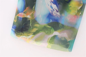 Close-up of artistic watercolor floral print on smooth vintage Y2K summer dress fabric