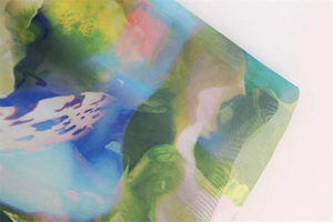 Detailed macro view of colorful floral print on lightweight translucent summer dress fabric