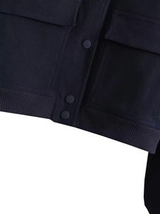 Detailed view of navy blue twill fabric texture and cargo pocket stitching on jacket