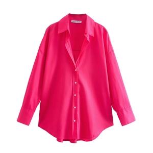 Front view of vibrant rose red oversized poplin shirt with white buttons and curved hem