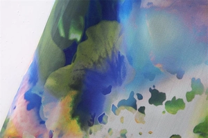 Macro detail of breathable Y2K mesh fabric with colorful abstract floral watercolor print