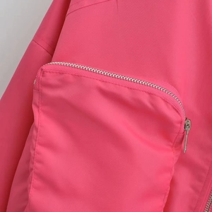 Pink Y2K bomber jacket featuring a large utility pocket with silver metal zipper detail