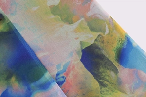 Close-up of lightweight breathable mesh fabric with vibrant colorful abstract floral print