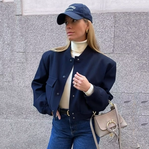 Women's dark blue cropped bomber jacket with stand collar and front pockets