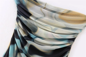 Detail of sheer mesh dress featuring blue marble print and ruched fabric texture