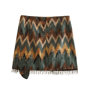 Detail view of Y2K mini skirt with zigzag print and black beaded fringe at the hemline