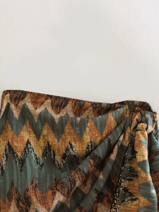 Detail of Y2K high waist skirt featuring zigzag patterns and side drawstring with beads