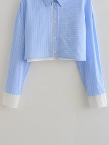 Detailed close-up of cropped Y2K striped shirt with vertical and horizontal patchwork panels
